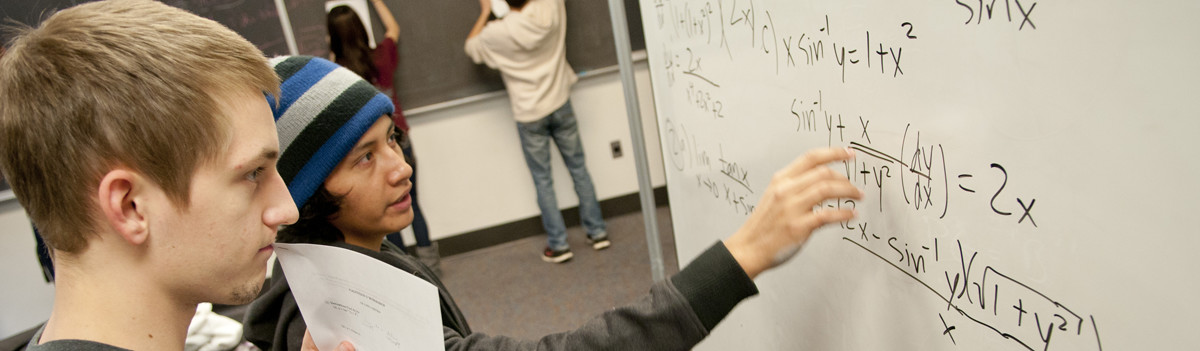 calculus students at white board